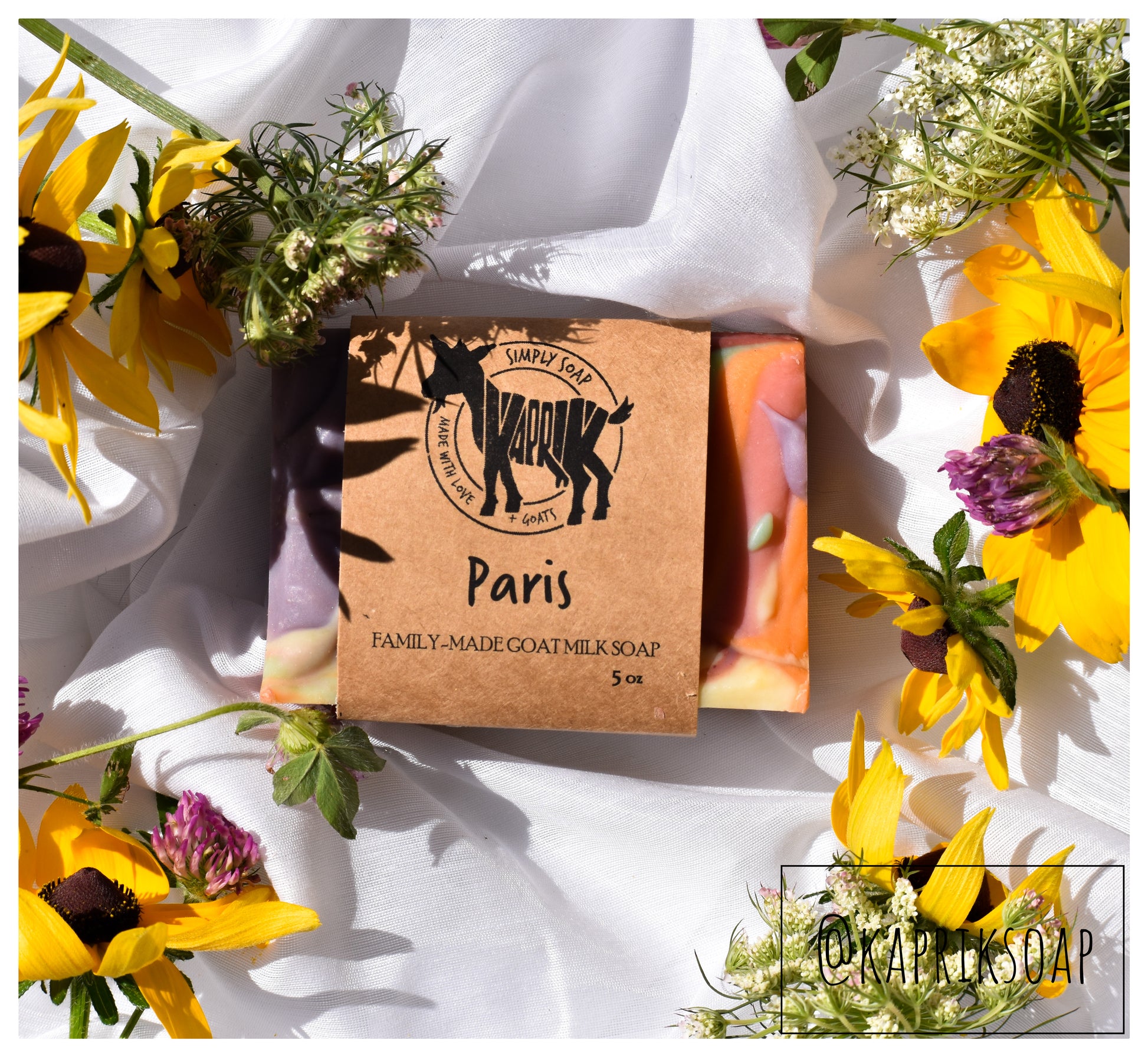 one bar of wrapped Paris cold process goat milk soap on white background with flowers